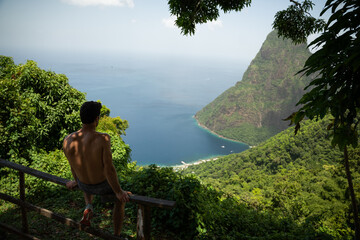 Person looking at view from the Tet Paul Nature trail of the Petit Piton on Saint Lucia.  Shot on a mirrorless camera midday on the Caribbean island nation of St. Lucia.