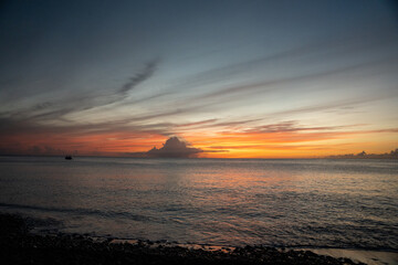 Beautiful colored sunset sky over Caribbean Sea from Saint Lucia beach.  Shot on a mirrorless camera with pink, orange, and blue colors in the sky.