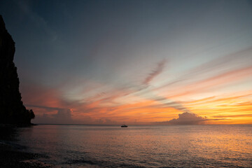 Beautiful colored sunset sky over Caribbean Sea from Saint Lucia beach.  Shot on a mirrorless camera with pink, orange, and blue colors in the sky.