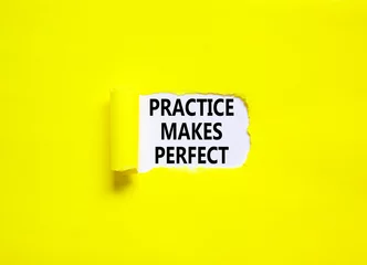 Fotobehang Practice makes perfect symbol. Concept words Practice makes perfect on beautiful white paper. Beautiful yellow background. Business practice makes perfect concept. Copy space. © Dzmitry