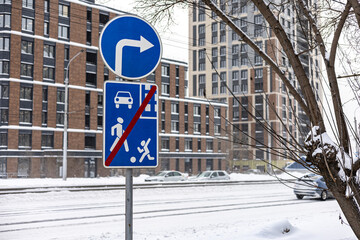 Fototapeta premium Winter Weather Driving. Winter safety. City road in winter, Road sings. No playing on road signage, turn right