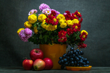 Still life with a bouquet of chrysanthemums and fruits