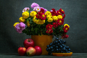 Still life with a bouquet of chrysanthemums and fruits © i_valentin