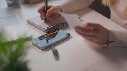 Female calculating family budget financial and accounting at home, young woman working with financial data calculator with tablet computer and writing make note calculate, pay bills tax online - Powered by Adobe