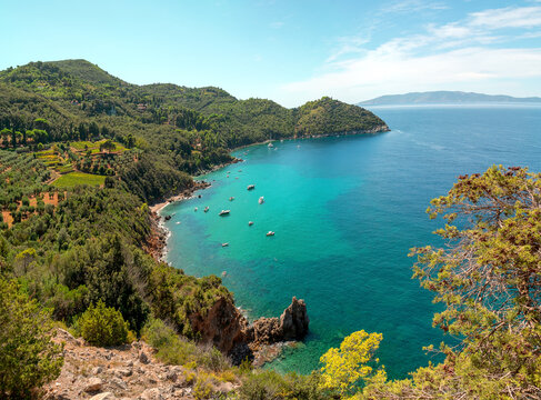 Beautiful mediterranean italian landscape. Aerial view from the panoramic road of the commune of Monte Argentario to the beach of Cala grande. Turquoise water of the Tyrrhenian Sea. Tuscany, Grosseto.