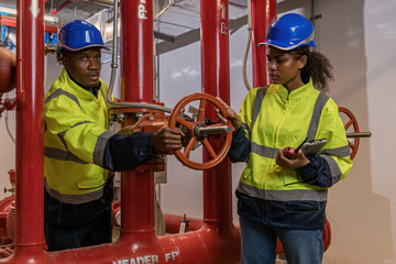 Engineer or technician work checking Fire suppression system and fire equipment. Engineer check red...