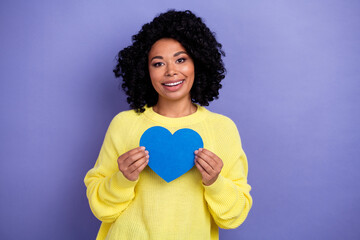 Portrait of lovely nice positive girl with chevelure wear knit pullover hold big blue heart in arms...