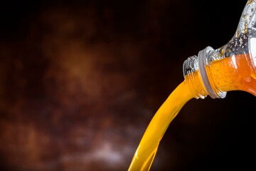 4K Image: Pouring Orange Juice from Plastic Bottle - Close-up Shot