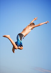 Jumping, blue sky and man with energy, outdoor and excited with nature, environment and water....