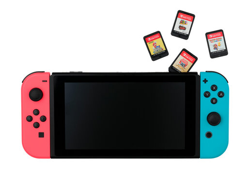 Nintendo Switch game console with the game cartridges flying out of it, isolated on white background. The Nintendo Switch is Nintendo seventh major home console platform, following the Wii U