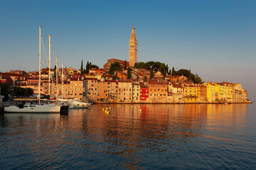 morning view of old  Rovinj town with multicolored buildings and yachts moored along embankment, Croatia. - 690341576