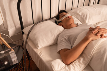 Asia man sleep with  Apnea Oxygen Mask Equipment And Cpap Machine