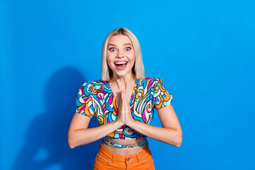 Photo of impressed cheerful lady open mouth arms palms plead empty space ad isolated on blue color...