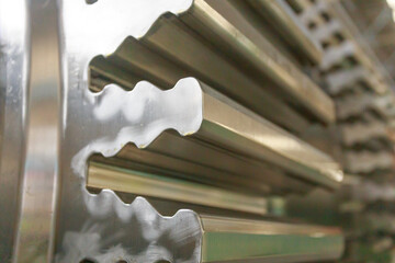 Important parts of steam turbine rotor at processing line in a factory workshop.