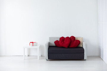 grey office sofa with holiday gifts in white room interior