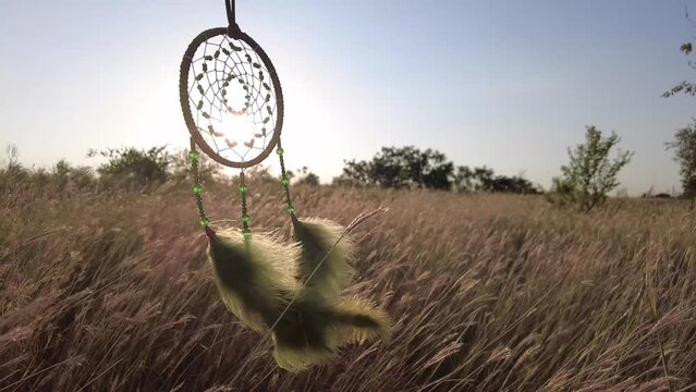 The sun shines through the mesh of the dream catcher.