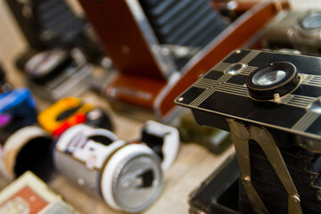 Close-up of Vintage Camera with Faded Equipment in Background