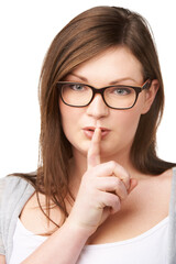 Naklejka premium Studio portrait and plus size model with secret for hush, gossip and privacy news with mystery by white background. Woman, face and emoji for shush with glasses, confidential and silence for noise