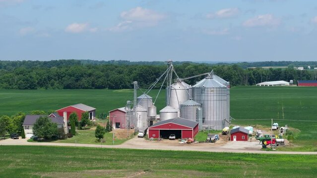 American rural farm with grain bins in Midwestern USA. Agricultural landscape in United States
