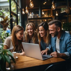 A group of coworkers gathered around a computer screen