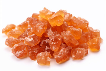 Heap of orange, amber colored raw dried gum arabic pieces on white background