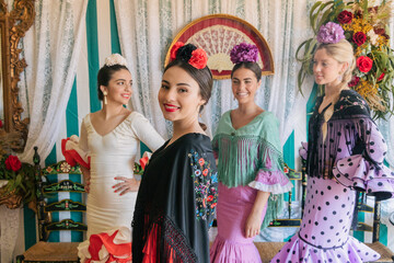 Cheerful female flamenco dancers in decorated hall