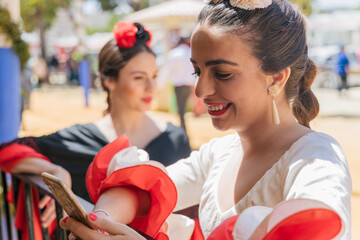 Laughing flamenco dancers with phone during city festival