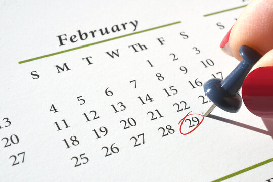 Marking Leap Year Day, February 29, on a calendar with a pushpin and red circle in ink