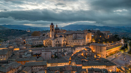 Italy, 14 December 2023 - Aerial view of the medieval village of Urbino, a UNESCO heritage site in the province of Pesaro and Urbino in the Marche region. Here you can breathe an air of past history - obrazy, fototapety, plakaty