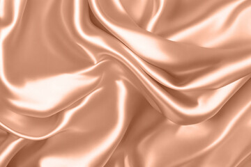 Fototapeta premium Abstract background, folds of silk fabric in peach fuzz color.