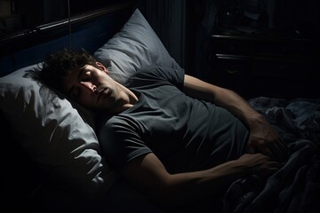 A man sleeping in bed at night. - obrazy, fototapety, plakaty