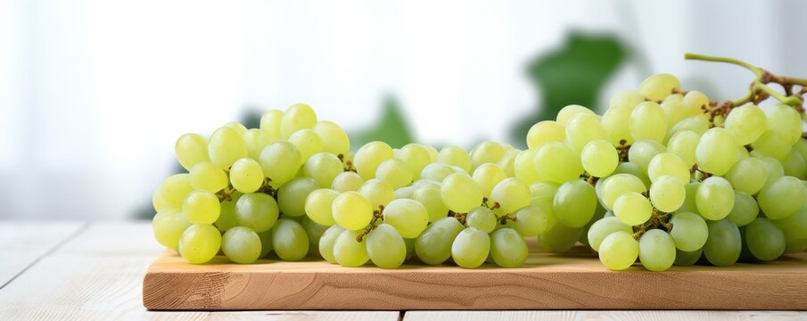 close up of green grapes with white wood background