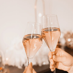 cheering with rose wine or champagne in pastel peach color palette. Color of the year 2024 peach...