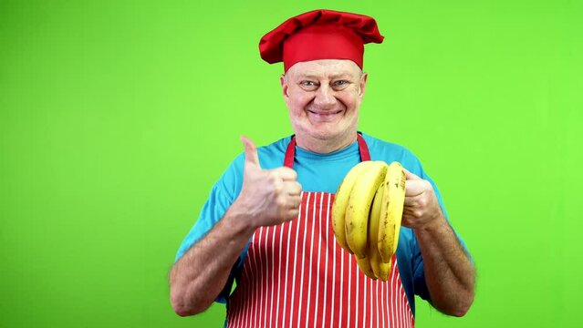 Senior cook pointing finger at stem bananas.