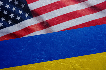 Flags of United States and Ukraine on the concrete wall