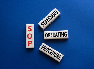 SOP - Standard Operating Procedure symbol. Wooden blocks with word SLA. Beautiful deep blue background. Business and Service Level Agreement concept. Copy space.