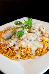 Close-up of Arroz con Pollo, Plated Mexican Grilled Chicken with Seasoned Rice and Cilantro Garnish