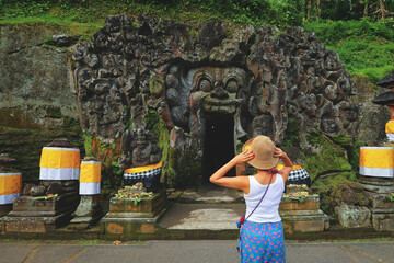 Tourist looking at Goa Gajah temple, also known as Elephant cave, famous landmark in Ubud, Bali, Indonesia