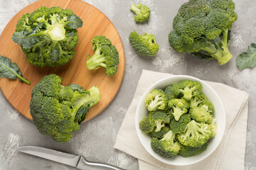 Fresh tasty broccoli on concrete background, top view