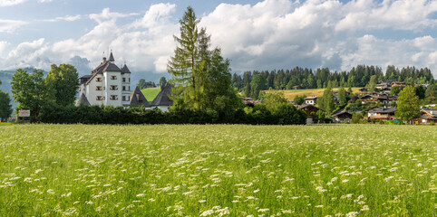 Muenichau castle with Wilder Kaiser mountain massif in the background