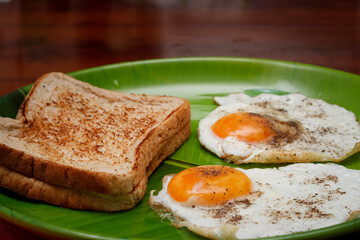 Toasted Bread And Sunny Side Up Eggs In Green Plate