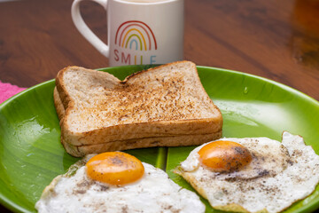 Toasted Bread And Sunny Side Up Eggs In Green Plate With Tea
