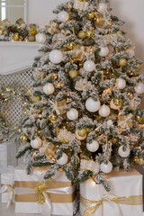 Decorated Christmas tree with golden ornament,balls and big gift presents for new year.A lot of packing handmade gift boxes lying under tree.winter holidays
