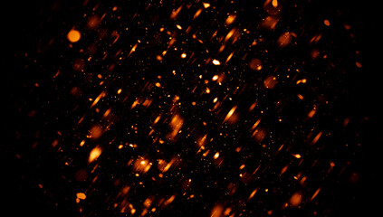 Blurred fire embers sparks on black background . Texture isolated overlays. Concept of particles, sparkles, flame and light. - obrazy, fototapety, plakaty