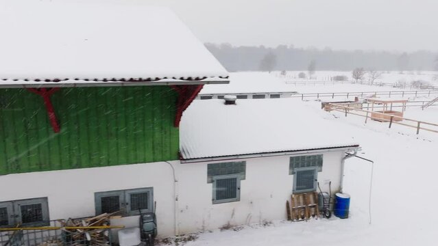Aerial view of a snowy farm with horses in northern germany