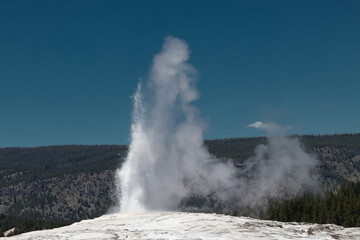 Old Faithful geyser in Yellowstone park