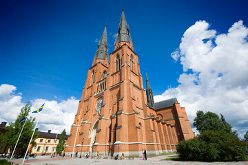 Uppsala Cathedral - the tallest church in the Nordic countries, Sweden. Unrecognizable people. - obrazy, fototapety, plakaty
