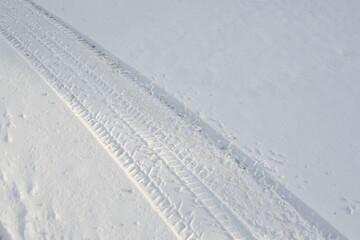 car tyre tracks on snow in the city, ozheliditsya, winter in the city on the road  