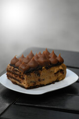 chocotorta with dulce de leche peaks on a plate on a table, with space for copying