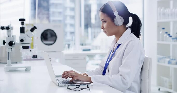 Science, woman on computer and headphones for laboratory research, music and typing report of test results. Young scientist or student on laptop with audio streaming or sound for medical software